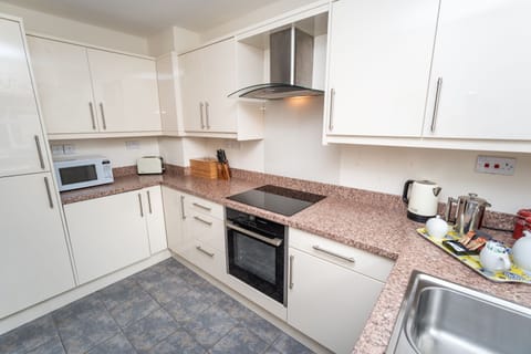 The kitchen has fully fitted units, electric fan oven & gas hob, fridge /freezer, dishwasher, microwave, and washer/dryer