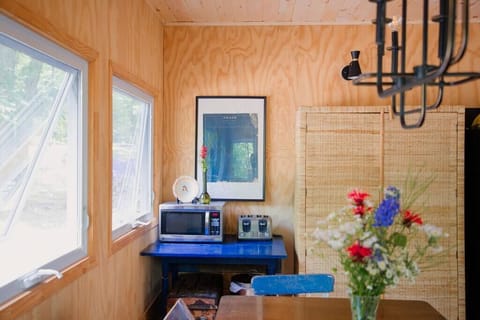The microwave and toaster nook is nestled right next to our rattan cabinet (filled with our collection of vintage plates, cookware, and glassware, and has plenty of room for all your favourite cottage eats).