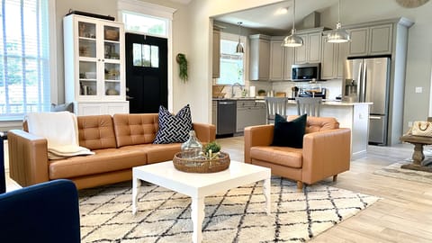 Open concept living room and kitchen, full of natural light
