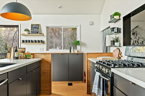 This fully equipped kitchen has a 4 burner stove, full size oven, dishwasher, microwave, Keurig coffee maker, juicer, and Nutri Bullet blender.