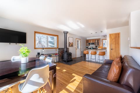 Main level living area offering a mounted Smart TV, surrounding windows, and new furnishings.