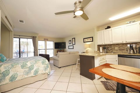 Unwind in your open-concept space where kitchen, living, and dining flow seamlessly together, complete with modern amenities and tropical bedding.