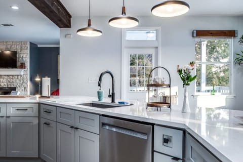 Kitchen island offers storage, dishwasher, sink and bar stools for more eat-in options.