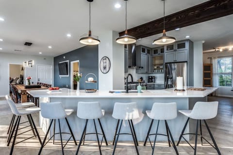 Spacious open floor plan.  Seven stools plus seating for 10 at the dining table.