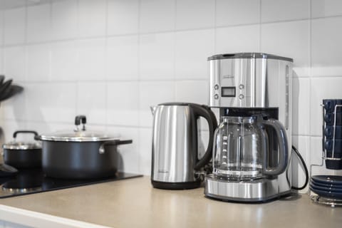 Sunbeam kettle and coffee maker, and kitchen cooking utensils.