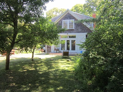 view from dirt road approaching barn; note parking area in left background