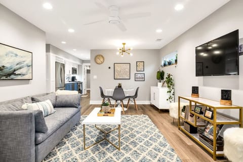Step into comfort with our chic, open-concept living room, designed for relaxation and entertainment. Unwind on the plush West Elm couch, enjoy the latest shows on the 55-inch smart TV, and indulge in musical nostalgia with our classic record player and S