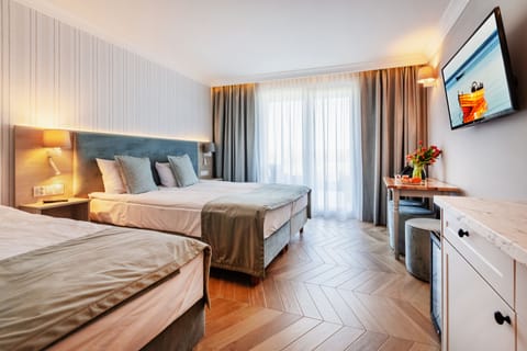 Deluxe Triple Room | Desk, laptop workspace, blackout drapes, cribs/infant beds