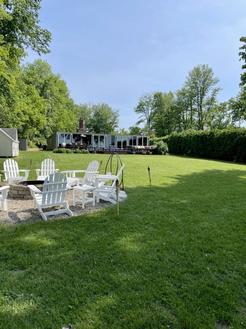 Lakeside view of house and yard with fire pit