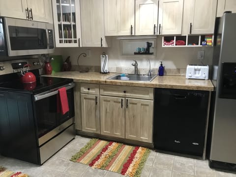 The kitchen has full-sized appliances, & the cabinets are generously equipped. 