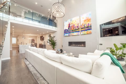 Loft Living Space with Deep, Comfortable Sofa, Smart Flat Screen TV & Fireplace
