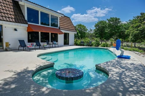Relaxing private pool with swim-up table in Austin Hill Country