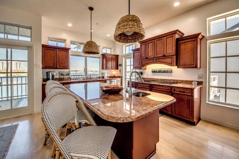 Full kitchen and bar seating overlooking the bay