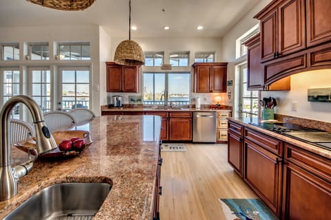 Full kitchen and bar seating overlooking the bay