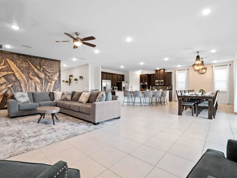 - Enjoy cozy evenings in this open living room with modern decor
- Comfortable sectional seating perfect for family gatherings
- Vacation rental near Disney with stylish family lounge