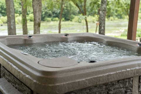 Relax in the private hot tub surrounded by peaceful nature