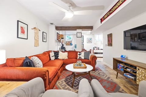 This expansive space offers ample room for relaxation and socializing, while tastefully displayed artwork adds a touch of sophistication and personality.