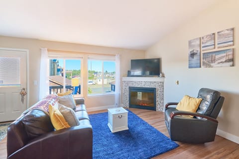 Enjoy the elagance of this upstairs living room with a cozy fire place and Roku TV