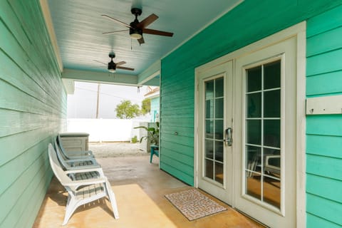 Relax on your private covered porch with comfortable seating and ceiling fans, perfect for morning coffee or evening unwind.