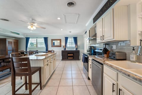 Kitchen with Granite counter tops and island. Stainless steel appliances.