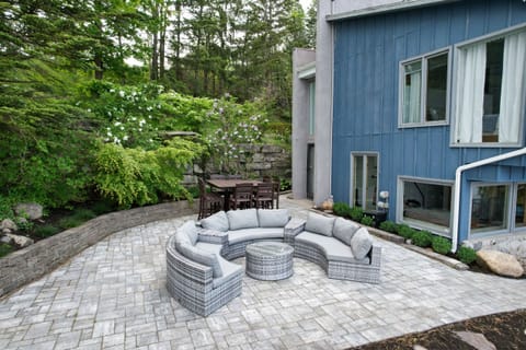 upper patio with a dinning area & sitting area. A waterfall behind for ambiance.