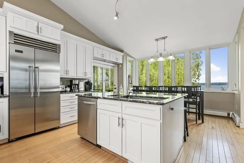 large fridge and deep farm sink basin. Table looking out at the lake sits 8.
