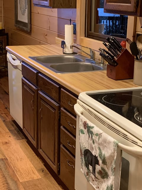 Electric oven/stove top, dishwasher, new knives, utensils, and tea kettle.