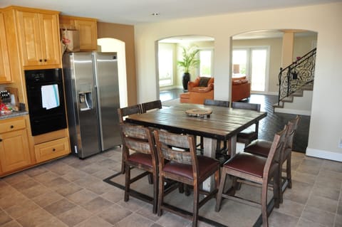 In kitchen, dining table with slider door to pool area. 