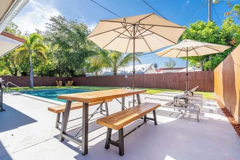 “Relax by the pool with shaded picnic tables—perfect for outdoor dining at your vacation rental.”