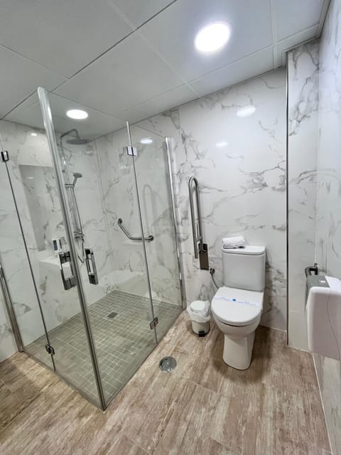 Accessible Twin Room for Guests with Disabilities | Bathroom | Hair dryer, towels