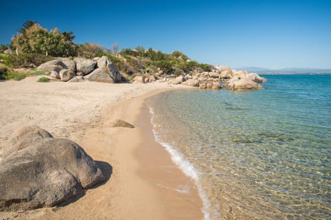 On the beach, white sand, sun loungers, beach umbrellas