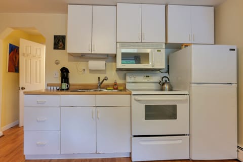 Kitchen with Full sized Refrigerator, Microwave, and Coffee Maker. 