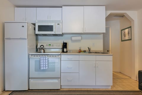 Kitchen with Full sized Refrigerator, Microwave, and Coffee Maker.