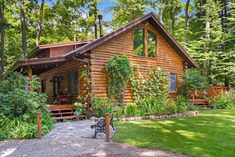 Classic wood cabin surrounded by nature, offering a peaceful retreat in a wooded setting.