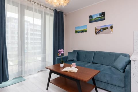 Relax in the stylish living room with a comfortable sofa and modern decor.