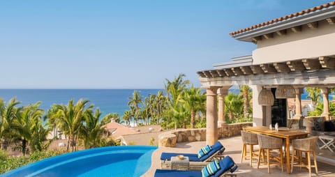The pool and patio space of Casita 6, with blue chairs by the side.