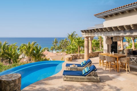 The pool and patio space of Casita 6, with blue chairs by the side.