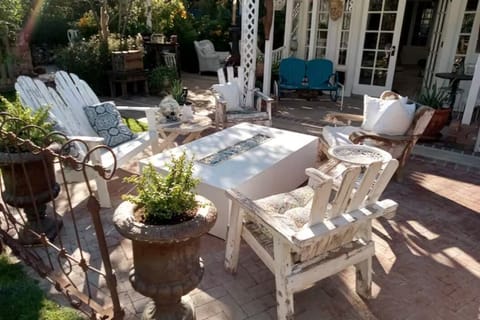 Gorgeous sitting area with gas firepit nestled in the beautiful yard.