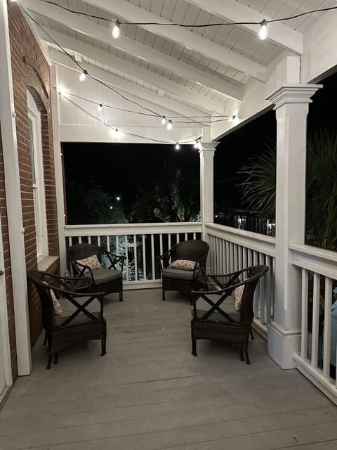 Large balcony with sitting and string lights overlooking downtown Apalach