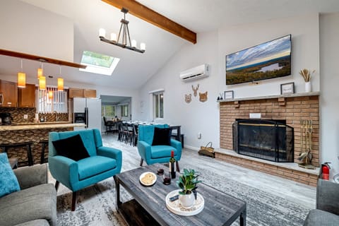 Cozy fireplace in the living room, featuring a TV and comfortable seating, perfect for relaxation and gatherings | Serhii Vacation Rentals