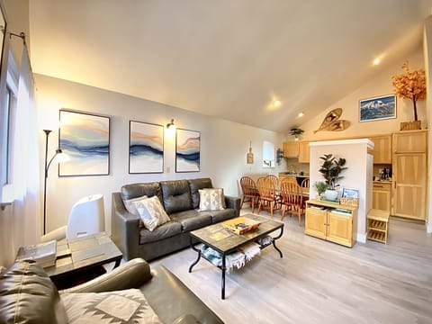 Open concept living room w/ vaulted ceilings. New paint and flooring throughout!