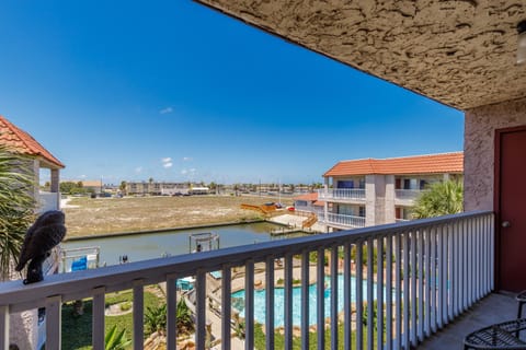 Sweeping views from your private balcony showcase sparkling pools, waterways, and coastal charm stretching to the horizon.