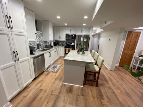 Fully stocked kitchen with full-size stainless steel appliances, and cookware.