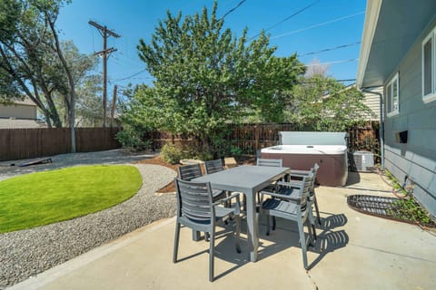 Relax and unwind in the spacious backyard, complete with a dining set and a private hot tub for ultimate outdoor comfort.