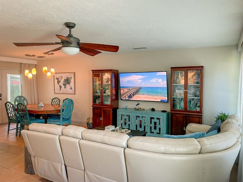 The living room with leather reclining sectional.