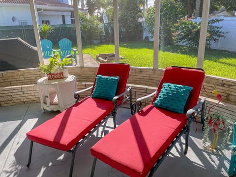 Covered screened in & furnished patio area attached to the back of the house.