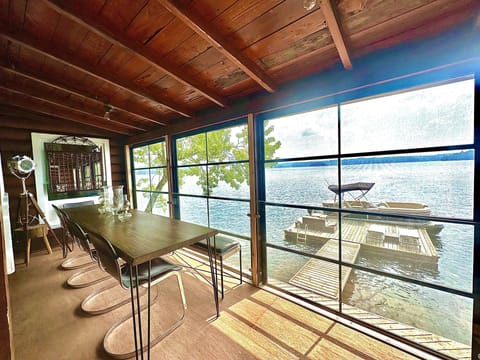 Main Cottage - screened in porch dining and view of dock an lake