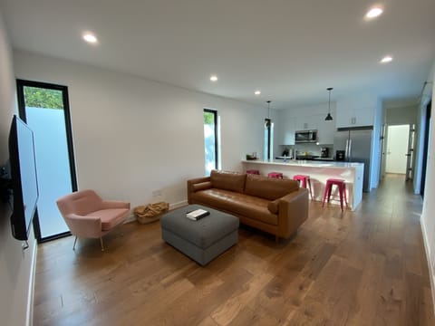 Spacious living room with open floor plan with full kitchen and island