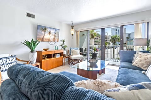 Bright & airy living room with sliding glass doors that lead to private balcony