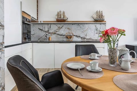 A marble-themed kitchen area with modern appliances, neatly organized for easy access and cooking.